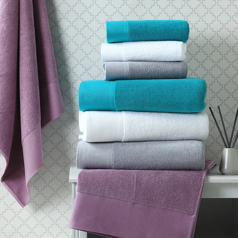 Soft pink Premier towels folded in a stack